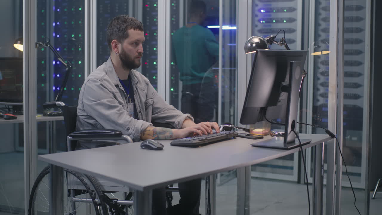 Man in Wheelchair Working in a Data Center