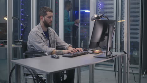 man in wheelchair working in server room