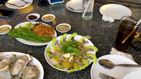 thai seafood meal with oysters and dipping sauces