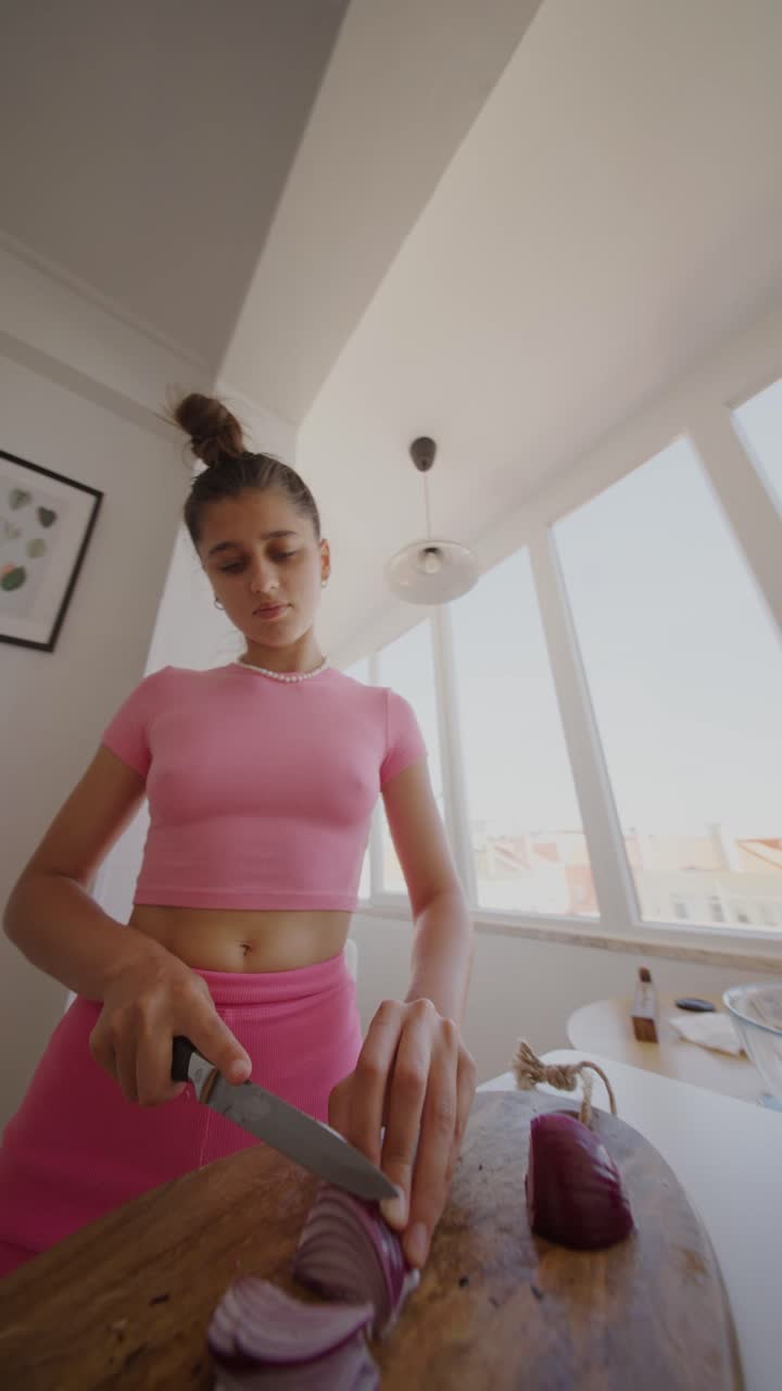 Woman cutting onions in the kitchen