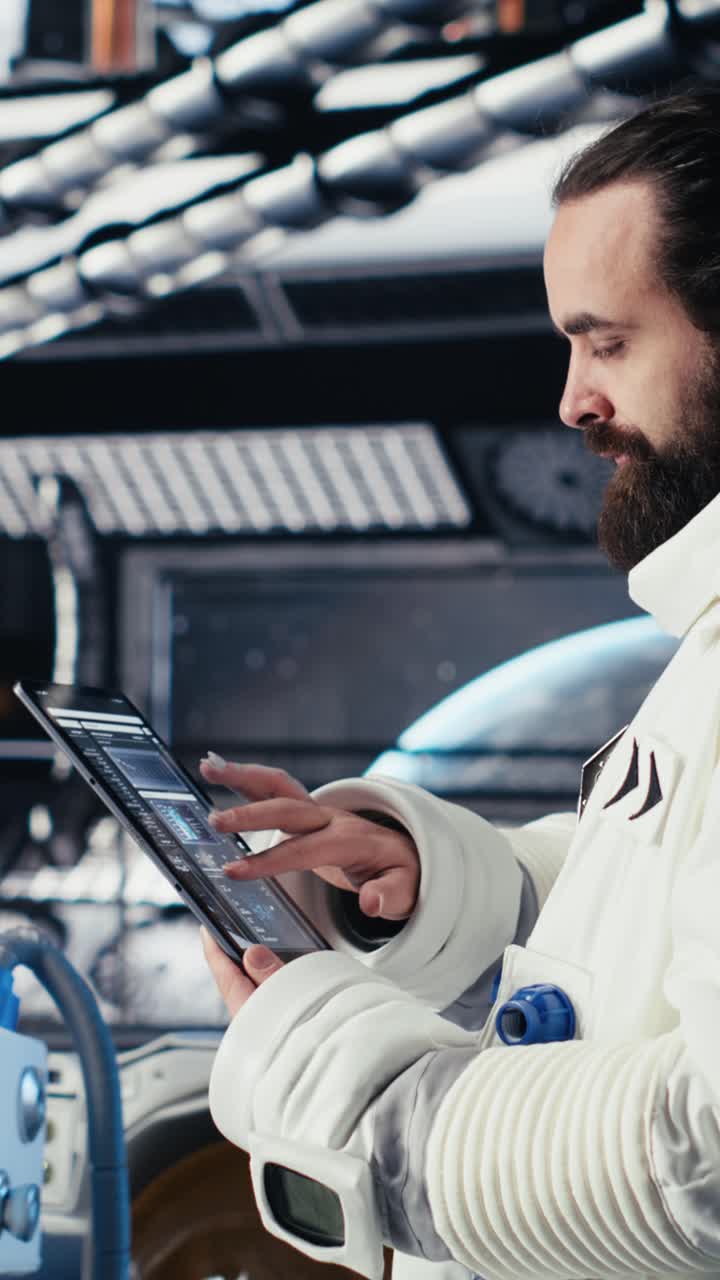Vertical video Astronaut using tablet to check space station analytics after completing mission