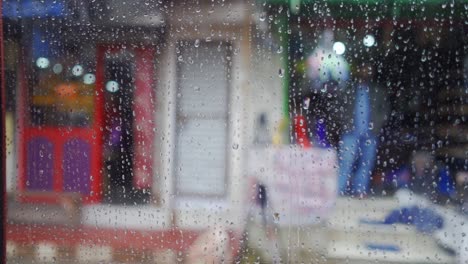 view from inside car window on rainy day, blurred faces of people and places, slow motion raindrops on glass