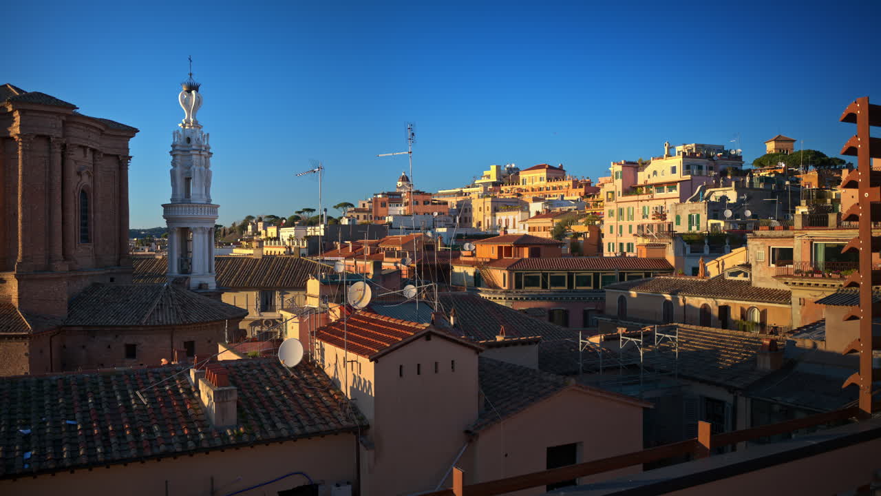 Rome city skyline from a rooftop with typical terracotta tile roofs of the buildings. Sunset in Italy