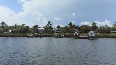 south florida coastline with real estate and boat lifts drone view sliding right