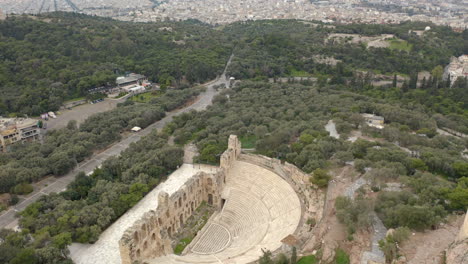 odeon of herodes atticus stone theater overhead aerial view reveal to athens cityscape