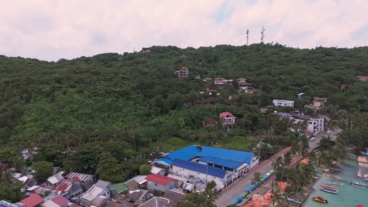 Aerial shot of Boracay’s coastal road, hillside villas, and boats anchored in crystal-clear waters. Perfect for travel, tourism, real estate, and island lifestyle projects