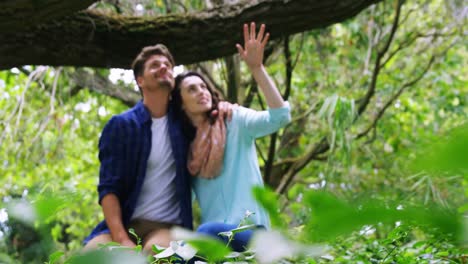 Romantic-couple-sitting-together-in-park