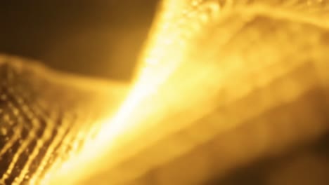 captivating light displays move fluidly across textured backgrounds, creating a mesmerizing visual experience with warm golden tones. perfect for relaxation or focus.