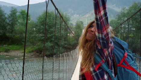 positive hitchhiker enjoy dancing on mountain vacation. woman move hands outside