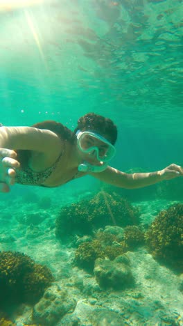 woman snorkeling underwater - vertical shot