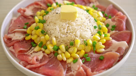 fresh pork raw sliced with rice and corn on white plate and ready to cook