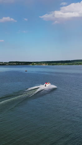 motor boat going fast on water. aerial drone view of boat sailing across river