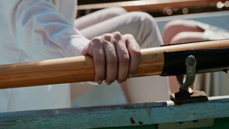 Romantic-date-of-a-couple-in-a-rowboat-during-a-sunny-day,-hand-close-up-and-romance-concept