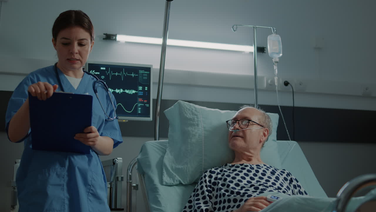 Medical nurse checking on patient in hospital ward at clinic