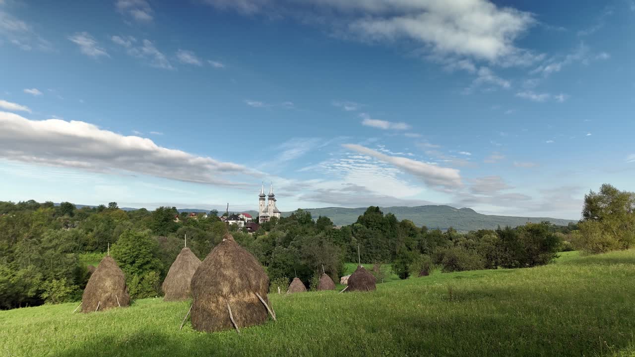 Conical haystacks in rural sunny day landscape, Breb village Romania