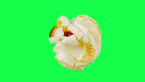 macro shots one popcorn rotating isolated on green screen background