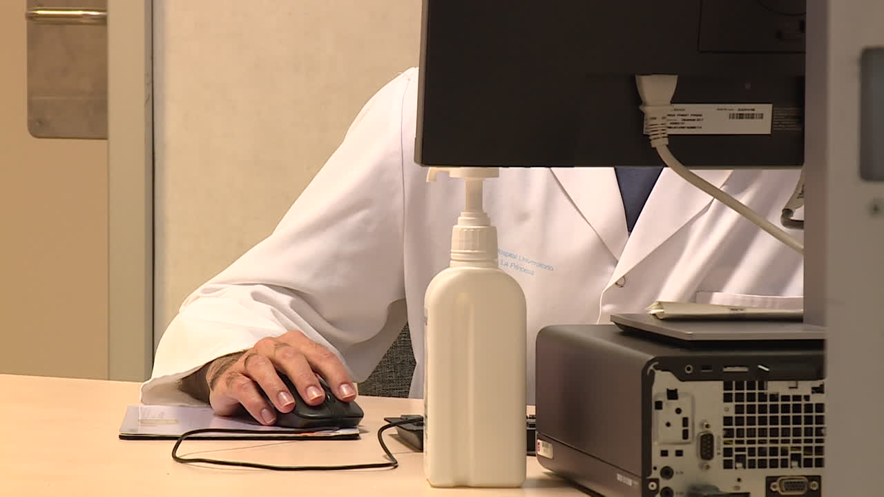 Doctor working at a computer in a hospital