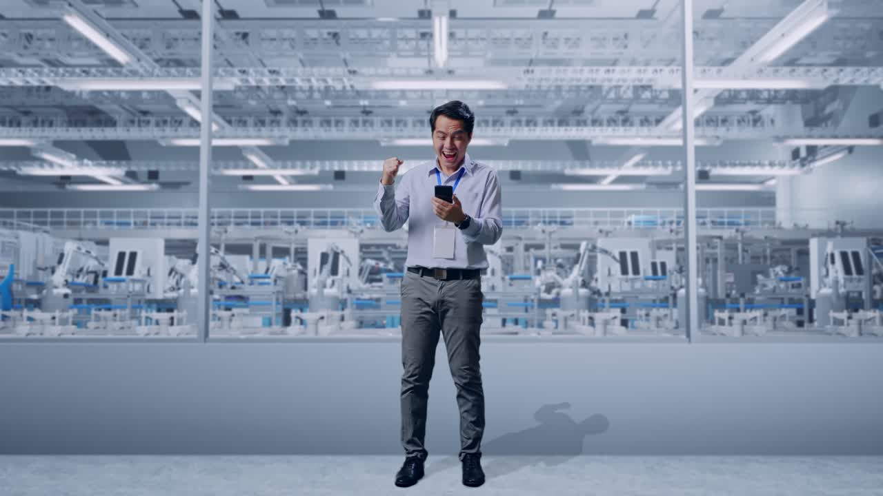 Happy Employee Celebrating Success in a Modern Factory