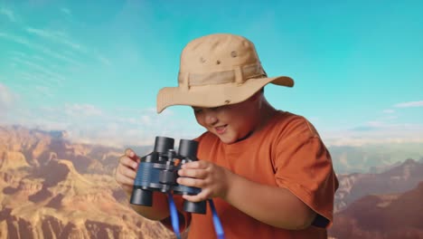 asian boy with a hat dancing after looking through the binoculars. boy researcher examines something while traveling at the top of mountain, travel tourism adventure concept, close up