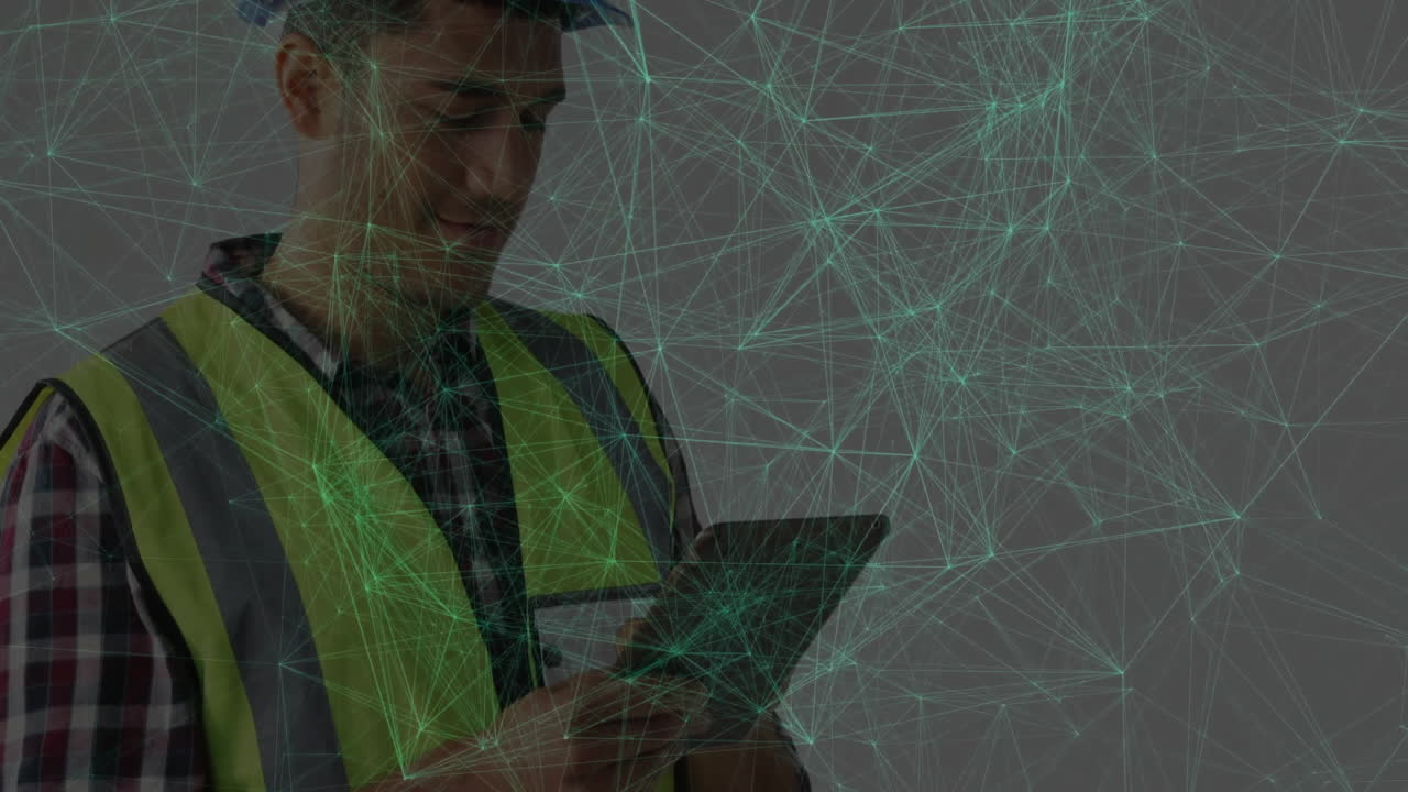Safety technician using tablet in studio, showing animated green technology network mesh