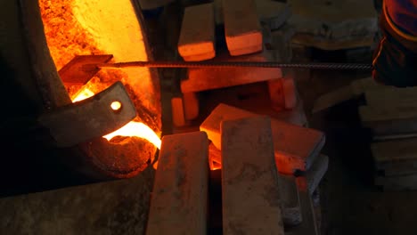 male worker pouring molten metal in mold at workshop 4k