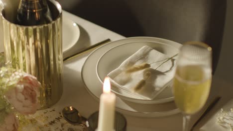 table set for meal at wedding reception with champagne in ice bucket 8