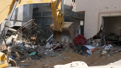 bulldozers clear the rubble of collapsed buildings in the city of rafah, palestine due to chaos created by israeli idf troops