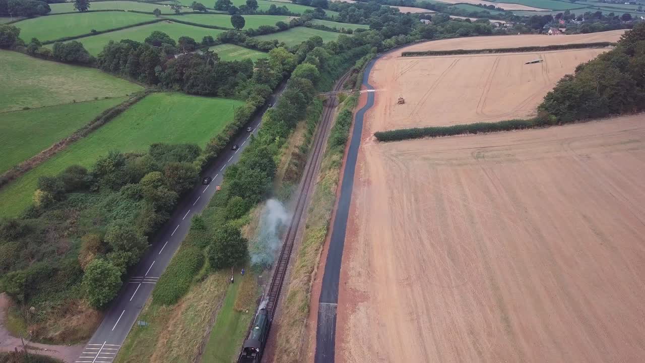 Aerial View of Steam Train Passing Through Countryside
