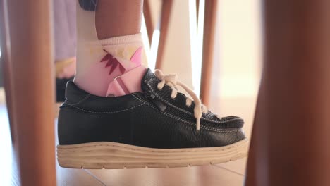 a young girl with a leg brace and ankle brace on her foot.