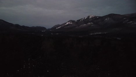 dark and snowy mountain landscape at night