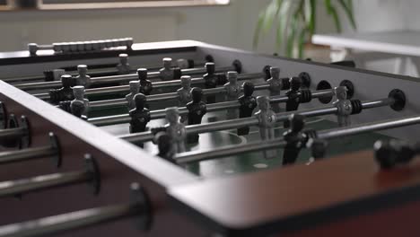 table soccer game in an office - modern work life lunch break - close up slowmotion