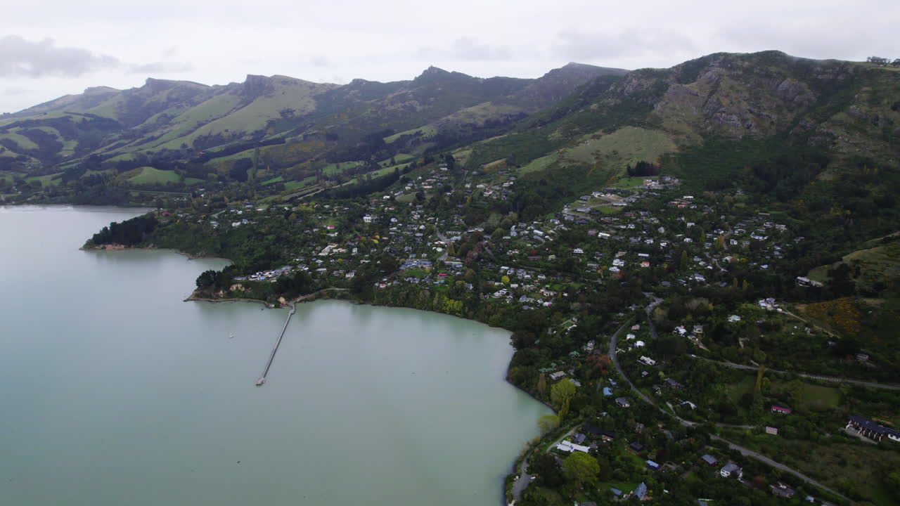 Drone circling the townscape of Governors Bay, cloudy evening, New Zealand