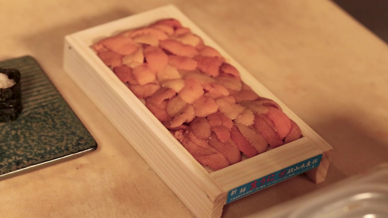 Chef Opening Wooden Box of Fresh Sea Urchin Uni