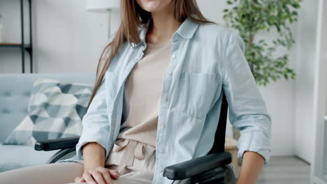 woman in wheelchair in a living room