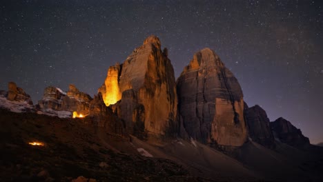 Starry Night Over Illuminated Tre Cime di Lavaredo Mountains