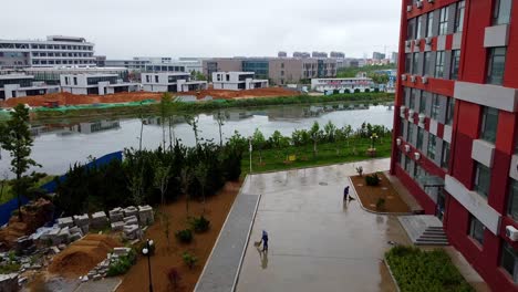 Courtyard-being-cleaned-by-two-Chinese-workers