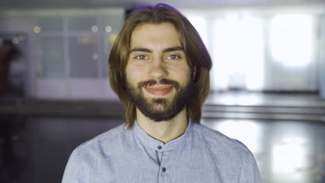 smiling man with long hair and beard