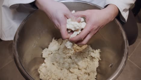 chef checks the quality of the pizza dough after kneading process