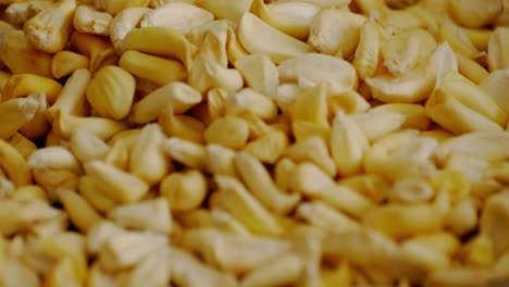 trowing cancha corn on a pan for toasting it