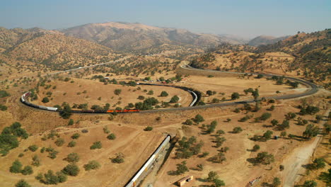 vista aérea del largo tren de carga que pasa por el circuito de tehachapi, california