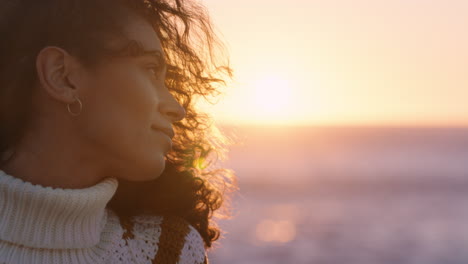 portrait of beautiful hispanic woman enjoying peaceful seaside at sunset exploring mindfulness contemplating spirituality with wind blowing hair