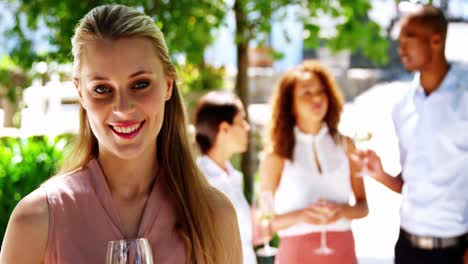 Beautiful-woman-holding-a-glass-of-wine-at-restaurant