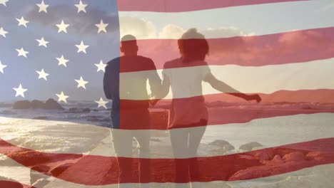 animación de la bandera de los estados unidos sobre una pareja afroamericana en la playa