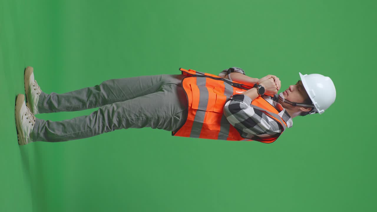 Full Body Side View Of Asian Male Engineer With Safety Helmet Pray For Something While Standing In The Green Screen Background Studio