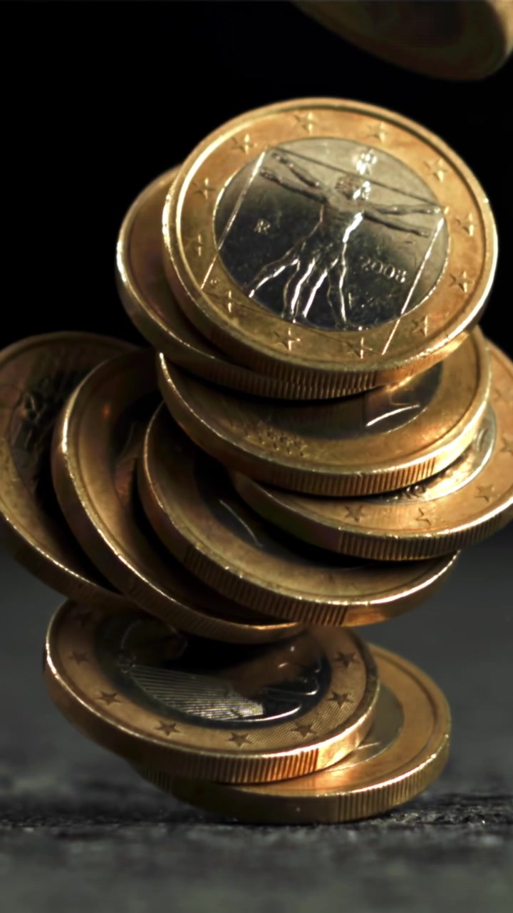 Euro Coins Stacked Precariously and Collapsing in Slow Motion