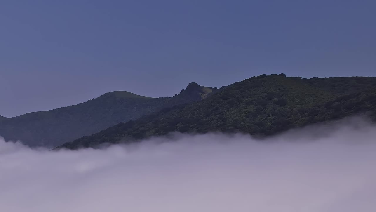 Misty mountains above clouds in Madeira, Portugal, from a drone