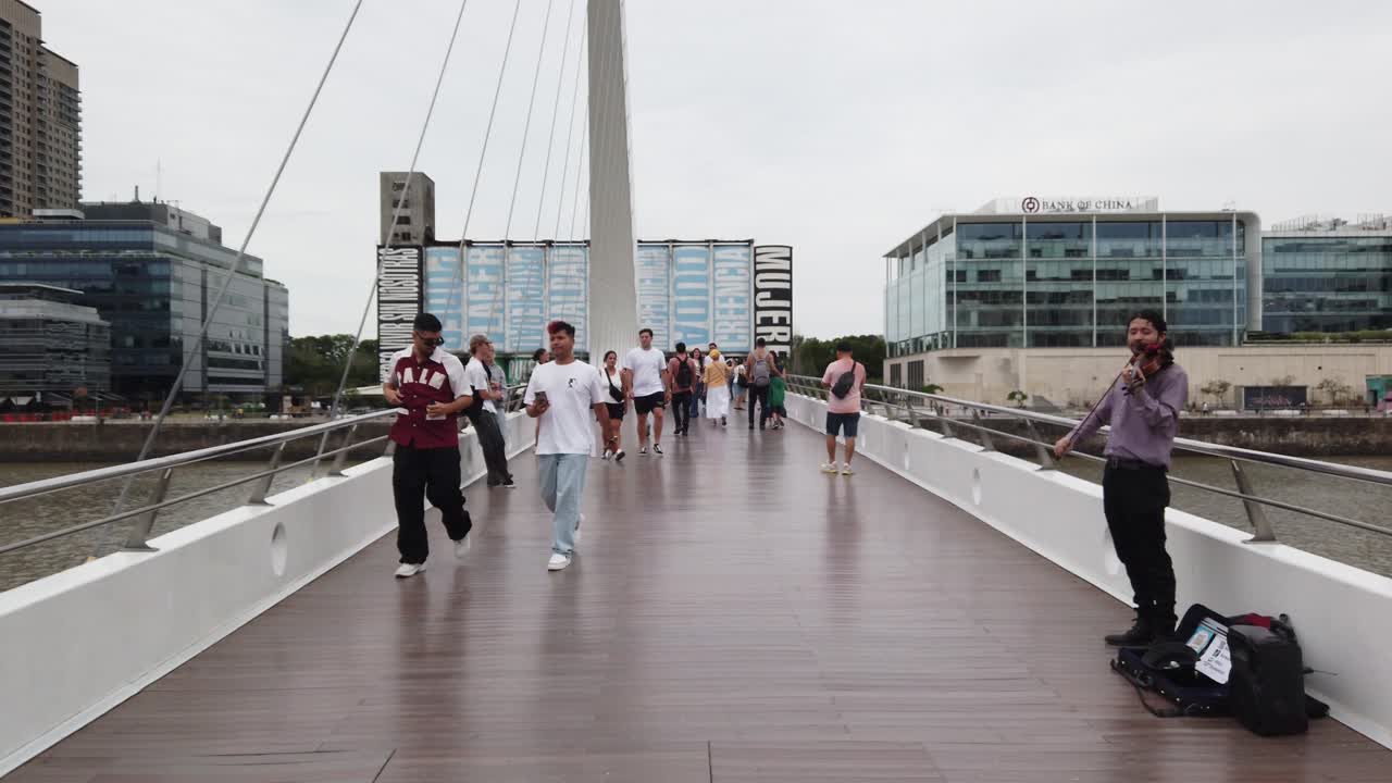POV Walk at Puerto Madero Women's bridge, international tourists visit downtown business center of Argentina