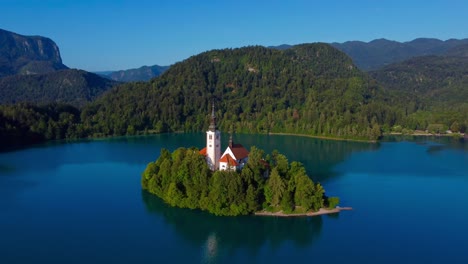 4k aerial view of lake bled island on a beautiful sunny morning - lake bled, slovenia