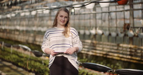 female gardener using digital tablet in greenhouse 5