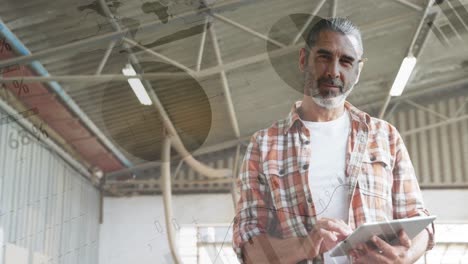 Man-typing-on-a-tablet-in-a-warehouse-4k